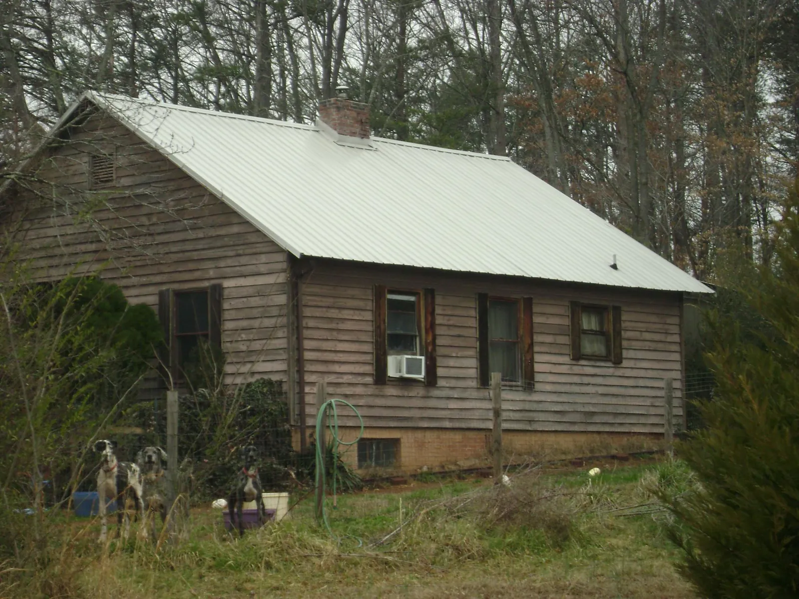 White metal roof on an old wood sided farmhouse, from a Metal Roof Installation job in Las Vegas